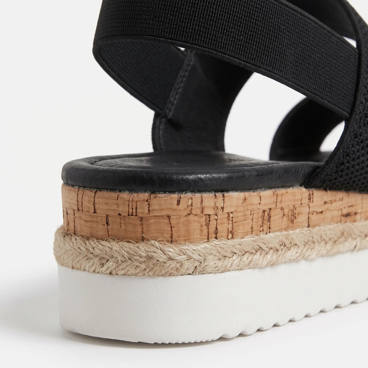 Mallow — Crossed elastic straps, esparto base, and comfortable platform