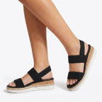 Mallow — Crossed elastic straps, esparto base, and comfortable platform