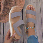 Mallow — Crossed elastic straps, esparto base, and comfortable platform